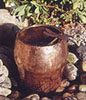 copper vase with a dragonfly perched on it