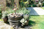 copper morning glory fountain in a half barrel